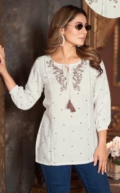 This short kurti is perfect for summer wear with jeans, shorts, or skirts. The embroidered yolk and 3/4th sleeves add a touch of elegance to this comfortable rayon fabric top. Hand wash in cold water and air dry for easy care. Effortlessly combine comfort and style : these easy breezy designs makes it the perfect choice for any occasion. Stay chic and comfortable with this versatile piece that will elevate your wardrobe. Short Kurtis And Jeans, Jeans Top Stitching Ideas, Sort Kurti Pent, Short Kurti Sleeves Design, Jeans Top Outfit For Women, Simple Short Kurti Designs, Casual Embroidered Straight Kurta Top, White Casual Tops For Festive Occasions, White Casual Top For Festive Season