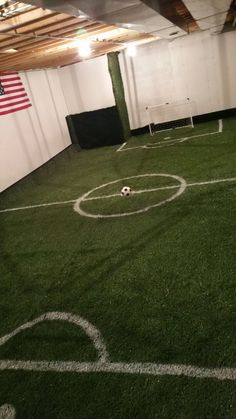 an indoor soccer field with white lines on the grass