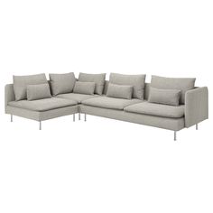 a large sectional couch with pillows on it's back and side ends, facing the camera