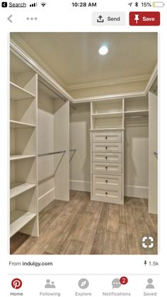 an empty walk in closet with white shelves and drawers