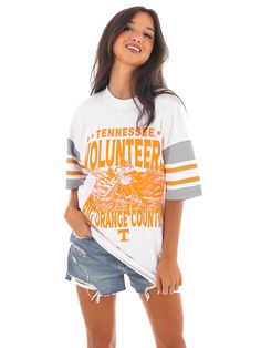 Get ready to rock the stands with this Tennessee Sports Stripe Raglan Tee! Show off your Big Orange spirit with a bold graphic and football jersey-style sleeves. Perfect for game day or any day, this tee is a must-have for any fan of Tennessee Volunteers (Go Vols!) Trucker Hat Fashion, Go Vols, Gameday Dress, Jersey Style, Tennessee Volunteers, Sports Uniforms, Outerwear Vest, Raglan Tee, Cardigan Vest