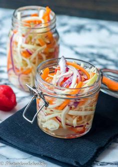 two mason jars filled with shredded carrots and radishes