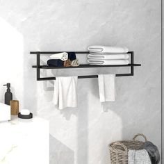 a black shelf with towels and other items on it in a white tiled room next to a sink