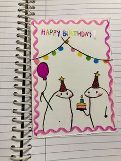 a spiral notebook with a happy birthday card on the cover and two unicorns holding balloons