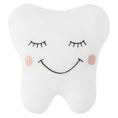 a tooth shaped pillow with eyes and eyelashes