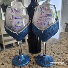 two wine glasses sitting on top of a counter