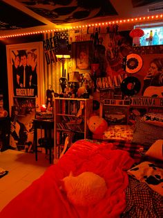 a bedroom with posters and lights on the walls