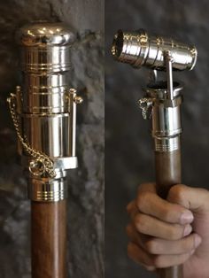 a person holding an antique telescope in their hand