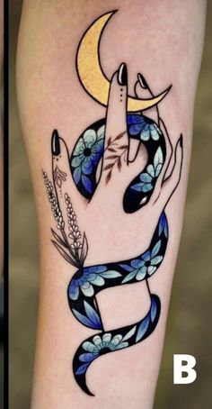 a woman's arm with a snake and moon tattoo design on the left side of her leg