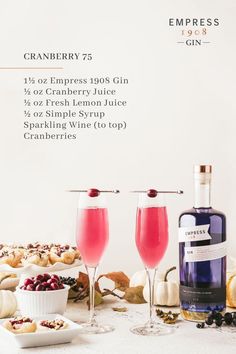 an advertisement for cranberry 75 gin with two glasses filled with pink liquid and garnishes