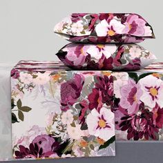 three floral sheets are stacked on top of each other