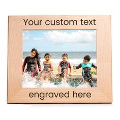 a wooden frame with three children playing in the water and an inscription that says your custom text