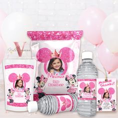 minnie mouse birthday party supplies including water bottle, napkins and cups with balloons in the background