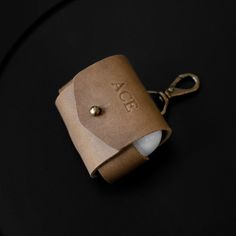 a leather keychain with the word aor on it