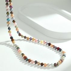 Drape yourself in elegance with our 35-inch Long Strand Multicolored Pearl Necklace. Composed of nearly round pearls in an array of captivating colors, this necklace is a testament to classic style with a playful twist. Its impressive length offers various styling options, making it a standout piece for any occasion. Product Information Pearl Type Freshwater Origin China Shape Nearly Round Quality AA+ Size 6-7mm Nacre Very Thick Color Multicolor Luster High Multicolor Round Beads Pearl Necklace, Multicolor Single Strand Pearl Necklace, Double Strand Pearl Necklace, Large Pearl Earrings, Popular Necklaces, Golden South Sea Pearls, Pearl Jewelry Necklace, Purple Pearl, Freshwater Pearl Bracelet