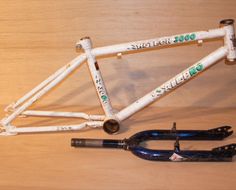 a bike frame and tools on a wooden table