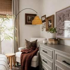 a living room filled with furniture and pictures on the wall