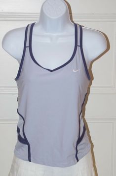 NIKE Women's Light Blue Dri-Fit Racer Back V-Neck Tank Top Navy Blue Trim Sz S NIKE Women's Light Blue Dri-Fit Racer Back V-Neck Tank Top Navy Blue Trim Sz S Details NIKE Women's Light Blue Dri-Fit Racer Back V-Neck Tank Top Navy Blue Trim Sz S Dri-FIT fabric to wick sweat away and help keep you dry and comfortable Racerback for full range of motion self bra Mesh back panels for enhanced breathability Flat-seams to help minimize chafing Nike logo embroidered on front Brand: Nike Size: S Material Blue Sporty Tops For Tennis, Sporty Blue Tennis Tops, Coraline Dolls, Tank Tops Outfit, 80's Clothes, Basketball Tank Tops, Tennis Tank Tops, Sport Clothing, Nike Tank Top