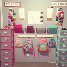 a room with several bins and bags hanging on the wall