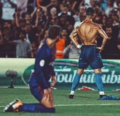 a man standing on top of a soccer field with his back turned to the camera