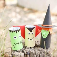 three paper cups with faces and witches on them