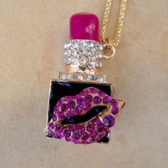 This Unique And Quirky Necklace Features A Deep Pink Lipstick Charm. A Pair Of Rhinestone Studded Lips Decorate The Front Of This Cosmetic Pendant. This Pendant Measures About 2" In Height And About 1.75" Across. It Hangs At An Angle From A 23" Gold Colored Chain And Comes With A 2.5" Extension. Has A Nice Weight To It. Brand New & In Excellent Condition. Perfect For Any Mua Or Beauty Queen! :) Pink Bling Necklace For Gift, Pink Rhinestone Necklace With Bling For Gift, Glamorous Pink Rhinestone Necklace For Party, Pink Crystal Rhinestone Necklace In Glamorous Style, Pink Rhinestone Bling Necklace For Gift, Purple Rhinestone Necklace For Gift, Pink Rhinestone Bling Necklace Gift, Pink Metal Novelty Jewelry, Punk Heart Charm Necklace For Valentine's Day