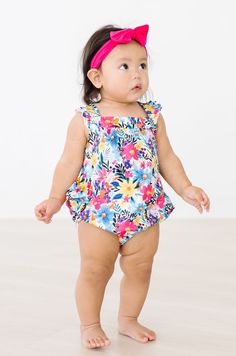 Our Ruffle Cross Back Romper is perfect for summer! Straps criss cross in the back with a sweet ruffle on the shoulder. Snaps for easy diaper changes. Also available in a matching dress! Perfect for big sister, cousin or BFF. Super soft fabric stays bright wash after wash. INSTRUCTIONS: Wear-Crawl-Repeat FIT & FABRIC & CARE: True to Size Polyester/Spandex Machine Wash/Tumble Dry Low Playful Flutter Sleeve Bubble Romper For Playtime, Playful Bubble Romper With Flutter Sleeve, Playful Bubble Romper With Flutter Sleeve For Playwear, Playful Flutter Sleeve Bubble Romper For Playwear, Cute Ruffled Bubble Romper For Vacation, Cute Bubble Romper With Ruffles For Vacation, Playful Sleeveless Bubble Romper With Floral Print, Cute Flutter Sleeve Bubble Romper For Playtime, Cute Bubble Romper With Flutter Sleeves For Playtime