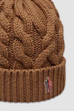 Taking you from the slopes to the city streets, this wool beanie is designed with warmth in mind. The heavy knit is part of the Moncler Grenoble collection. Brown Wool Beanie For Fall, Winter Wool Knitted Beanie, Knitted Wool Beanie For Winter, Brown Wool Beanie For Winter, Winter Wool Cable Knit Hat, Brown Wool Knitted Beanie, Brown Knitted Wool Beanie, Cozy Brown Wool Beanie, Wool Knitted Beanie Cap