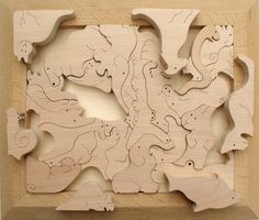 a wooden puzzle with different animals on it's sides and an opening in the middle