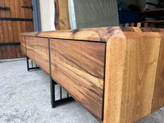 a close up of a wooden bench with metal bars on the bottom and wood in the middle