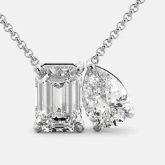 Our Toi et Moi Diamond Necklace. This particular necklace features a stunning emerald-cut Diamond and a pear-shaped Diamond, set side-by-side in a delicate prong setting. The contrast between the two shapes is both eye-catching and elegant. Features: Diamond (G/VS1) 0.55ct or 4.5ct Two-stone design 14K white, yellow, or rose gold Adjustable chain Secure lobster claw clasp Benefits: GIA Diamond Certificate for 4.5 ct Helps focus your energy and amplify your intentions Valuable investment Highest Formal Emerald Cut Solitaire Necklace With Cubic Zirconia, Formal Emerald-cut Solitaire Necklace In Cubic Zirconia, Classic White Gold Emerald Necklace With Diamond Accents, Formal Platinum Necklace With Emerald Cut, Elegant White Gold Teardrop Emerald Necklace, Exquisite White Gold Necklace With Emerald Cut, Luxury Pear-shaped Emerald Necklace In White Gold, Formal White Gold Pear-shaped Emerald Necklace, Luxury Pear-shaped White Gold Emerald Necklace