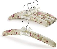 three flowered hangers with bows on them