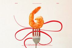 there is a fork with shrimp on it and red ribbons around the forks, which are connected to each other