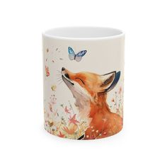 a coffee mug with a fox and butterfly on it