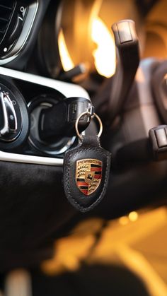 there is a car keychain in the middle of a vehicle's steering wheel