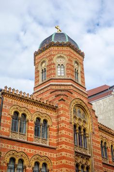 an old brick building with a cross on top