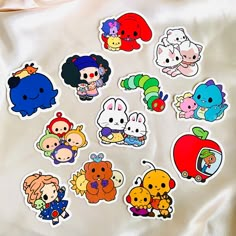 a bunch of stickers sitting on top of a white sheet