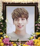 a photo frame with flowers around it and a young person's face in the middle