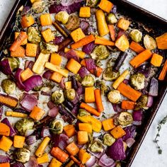 roasted vegetables on a baking sheet with herbs