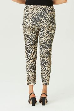 Step out in style with the In the Wild 7/8 Stretch Pant in Black Mix. Featuring a bold animal print, these pants offer a chic and modern look. The 7/8 length and pull-on design with a drawstring waist tie provide comfort and ease. Front stitch rounded jean pockets add a touch of practicality to this fashionable piece. Printed animal design 7/8 length Pull-on style Drawstring waist tie Front stitch rounded jean pockets Our Model Chella is wearing a size XS. She is 175cm tall with an 89cm bust, 74cm waist and 96cm hips. Chic Leopard Print Workwear Bottoms, Chic Leopard Print Pants For Work, Chic Leopard Print Trousers, Chic Stretch Leopard Print Bottoms, Trendy Leopard Print Pants For Work, Jean Pockets, Winter Warmers, Cardigan Vest, Stretch Pants