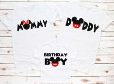 two shirts that say, mommy and daddy with mickey mouse heads on the front in black