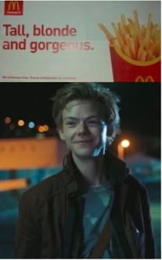 a man standing in front of a sign with french fries