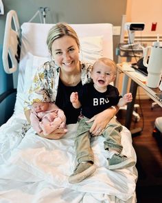 a woman sitting next to a baby in a hospital bed with her arm around the baby's leg