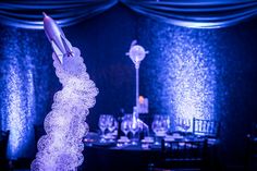 a rocket ship on top of a glass vase in the middle of a banquet table