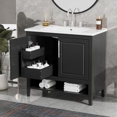 a bathroom with a sink, mirror and towel rack