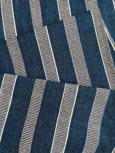 blue and white striped fabric with vertical stripes on the bottom, diagonally arranged in rows