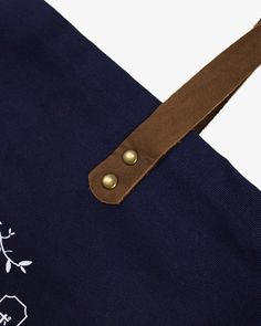 A simple everyday tote to carry your belongings or groceries. Made here in our Portland studio, with high-quality canvas duck and leather. Screen-printed with Kiriko's emblem, representing indigo leaves and dyes. *The color and texture of leather straps may vary depending on what is available. Sewn in Portland, OR Screen printed on one side, blank on the other #10 (14.75 oz) canvas duck Leather handle, antiqued brass rivets One inside pocket Size: 17.5" x 14" Product #: CT16 Code: WP35 Everyday Tote, Japanese Textiles, Large Canvas, Leather Handle, Inside Pocket, Canvas Tote, Clothing Brand, Leather Straps, Screen Printing