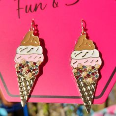 the earrings are decorated with ice cream and sprinkles on it's sides