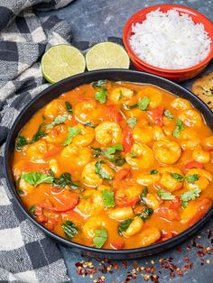 a bowl filled with shrimp and rice next to some bread