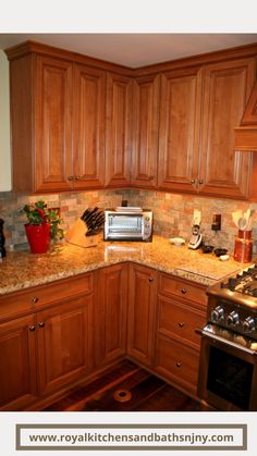 a kitchen with wooden cabinets and granite counter tops, including a microwave oven in the corner